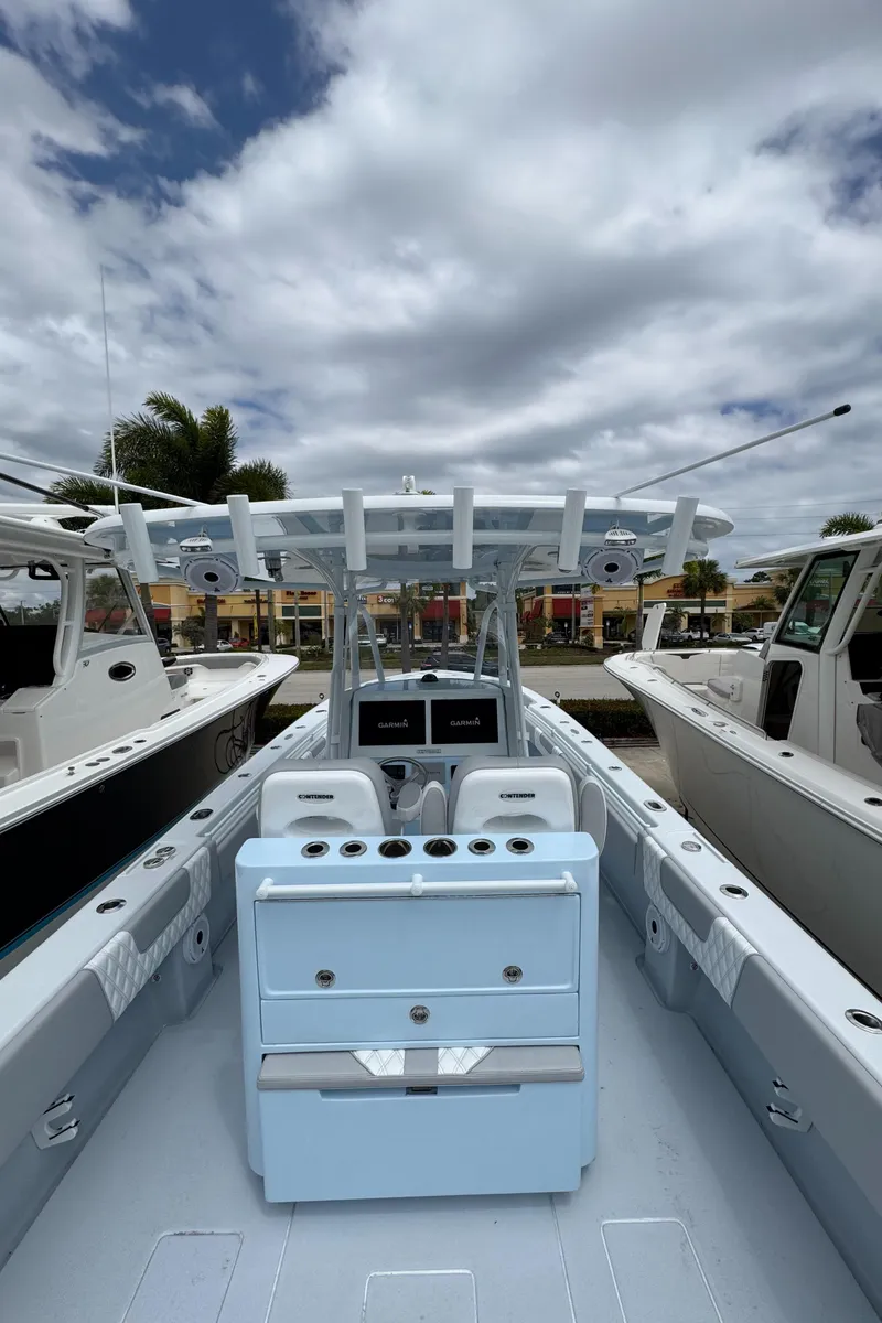 Slide: The Image of 2025 Contender 35 ST boat with sleek design, docked under cloudy sky. - 6