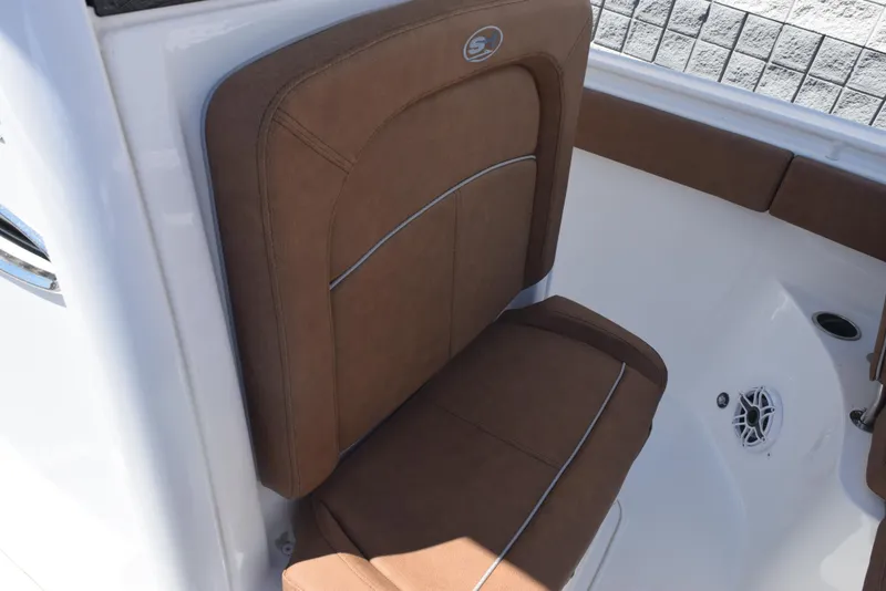 Slide: The Image of 2025 Sea Hunt Ultra 255 SE boat seat with brown upholstery and white interior. - 12