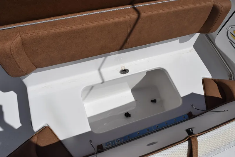 Slide: The Image of 2025 Sea Hunt Ultra 255 SE boat seating with storage compartment. - 16