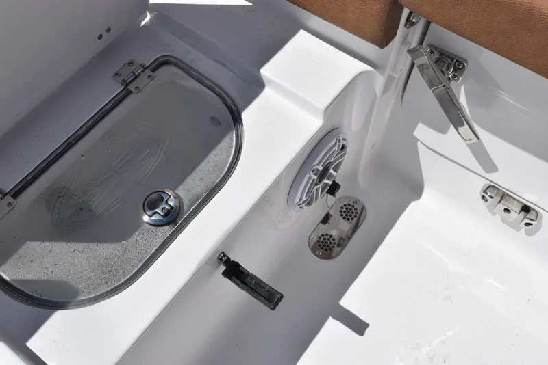 Slide: The Image of 2025 Sea Hunt Ultra 255 SE boat interior, featuring storage compartment and speaker. - 17