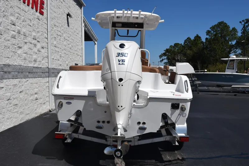 Slide: The Image of 2025 Sea Hunt Ultra 255 SE boat with 350 V6 engine, parked outdoors. - 4