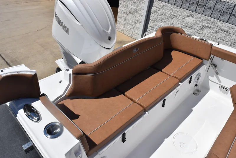 Slide: The Image of 2025 Sea Hunt Ultra 255 SE boat with brown cushioned seating and Yamaha engine. - 6