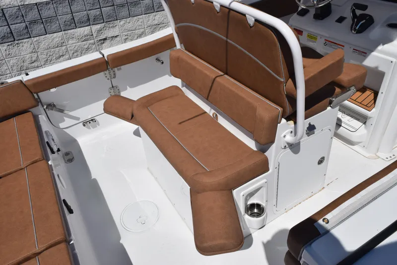 Slide: The Image of 2025 Sea Hunt Ultra 255 SE boat interior with brown cushioned seating. - 7