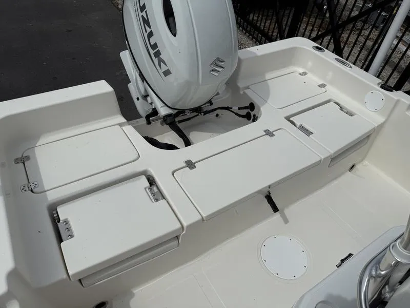 Slide: The Image of 2025 Bulls Bay 2200 XS boat deck with Suzuki outboard motor, featuring storage compartments. - 11