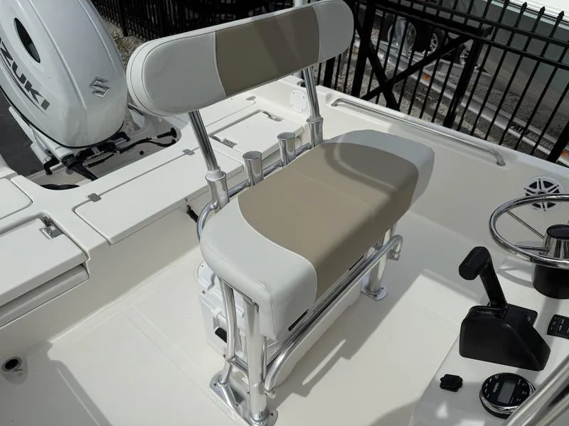 Slide: The Image of 2025 Bulls Bay 2200 XS boat interior with beige and white seating and Suzuki engine. - 14