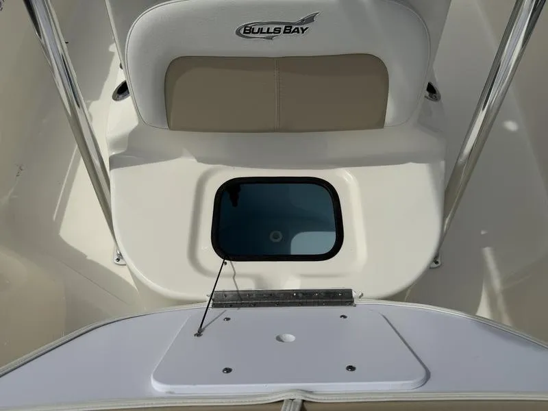 Slide: The Image of 2025 Bulls Bay 2200 XS boat interior with seating and storage compartment. - 15