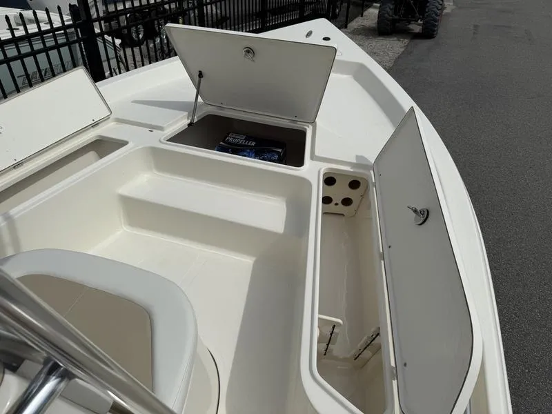 Slide: The Image of 2025 Bulls Bay 2200 XS boat with open storage compartments on deck. - 6
