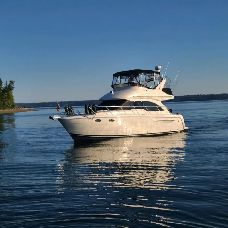 Slide: The Image of 2004 Meridian 341 yacht on calm water under clear blue sky. - 1