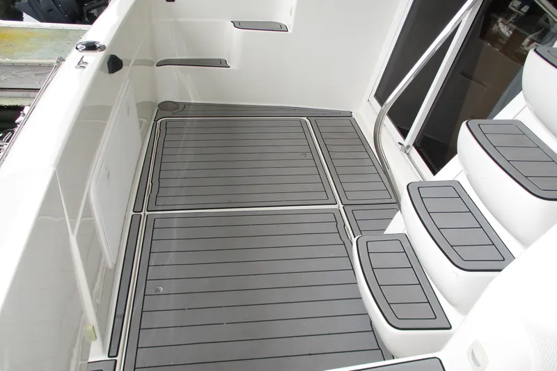 Slide: The Image of 2004 Meridian 340 boat deck with gray non-slip flooring and steps. - 11