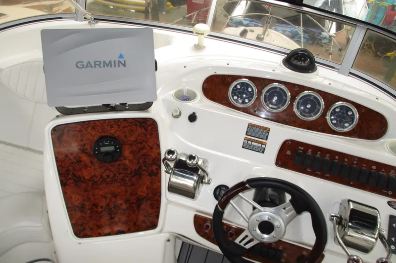 Slide: The Image of 2004 Meridian 340 boat dashboard with Garmin navigation system and wood paneling. - 13