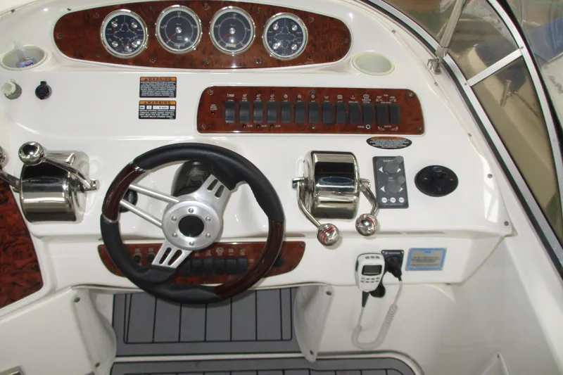 Slide: The Image of 2004 Meridian 340 boat dashboard with steering wheel and control panel. - 14