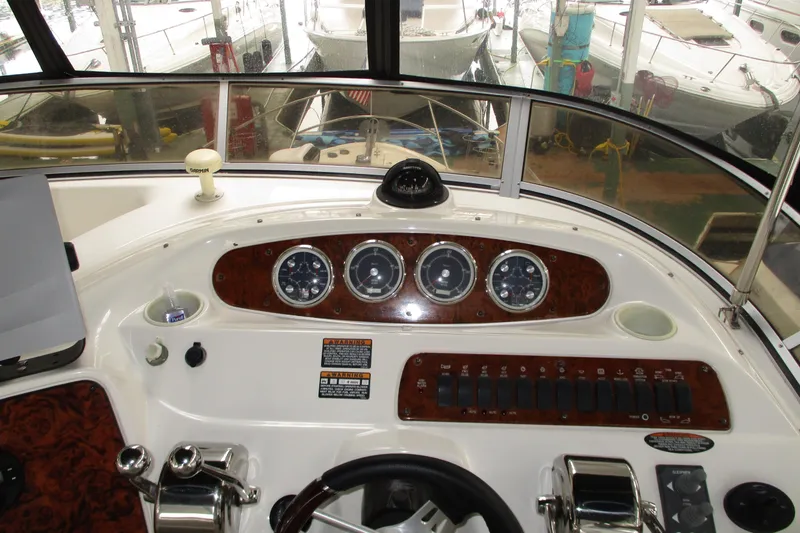 Slide: The Image of Helm of 2004 Meridian 340 yacht with gauges and controls, docked in marina. - 15