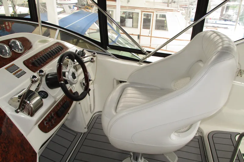 Slide: The Image of 2004 Meridian 340 yacht helm with white captain's chair and control panel. - 16