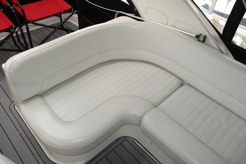 Slide: The Image of White leather seating on a 2004 Meridian 340 boat, with red chairs in the background. - 17