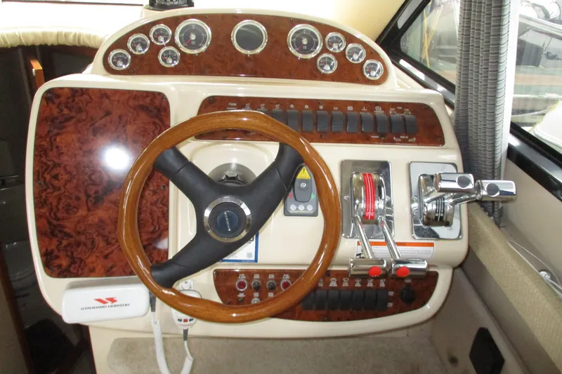 Slide: The Image of 2004 Meridian 340 helm with wood accents and control panel. - 20