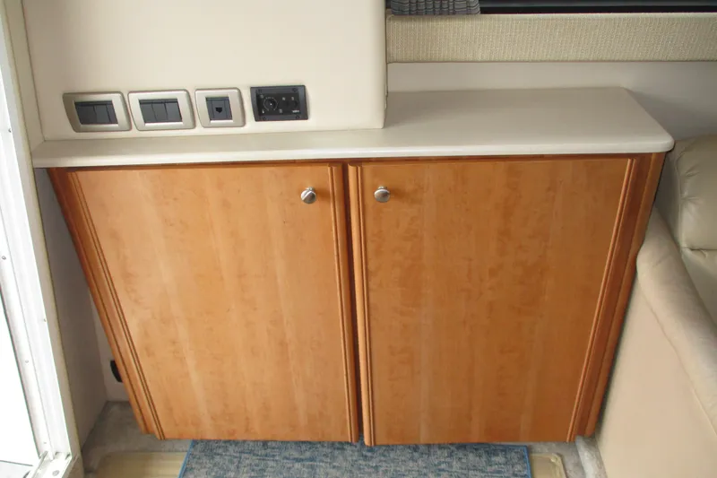 Slide: The Image of Wooden cabinet with countertop and electrical outlets in a 2004 Meridian 340 boat interior. - 25
