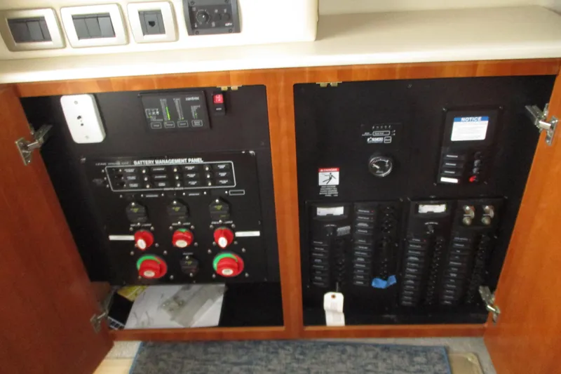 Slide: The Image of Electrical control panel inside a 2004 Meridian 340 boat, featuring battery management and switches. - 26