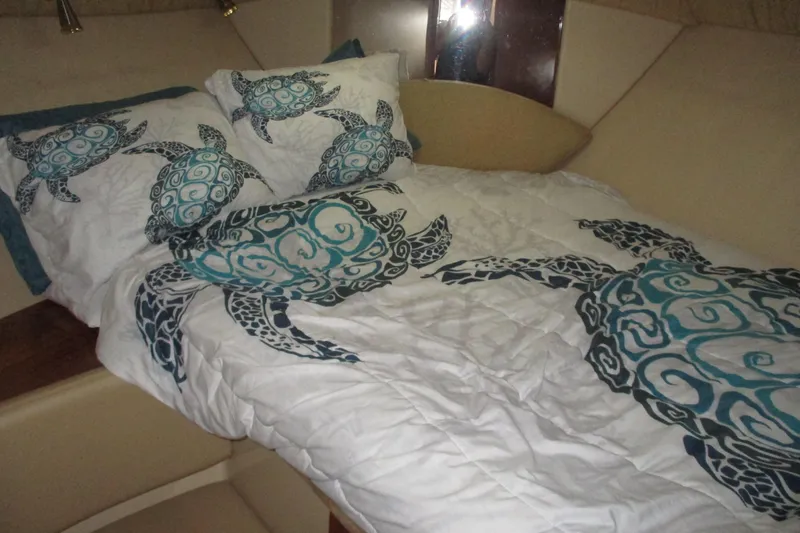 Slide: The Image of Cozy 2004 Meridian 340 cabin with turtle-themed bedding and soft lighting. - 28