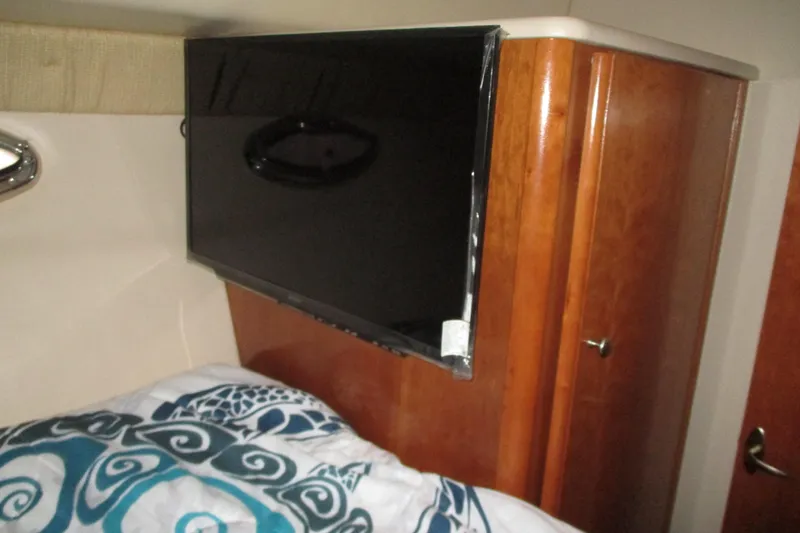 Slide: The Image of Flat-screen TV in 2004 Meridian 340 yacht cabin with wooden cabinetry. - 29
