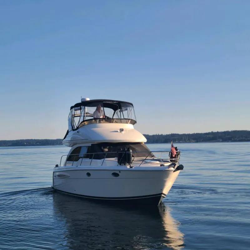 Slide: The Image of 2004 Meridian 341 yacht cruising on calm waters under clear blue sky. - 3