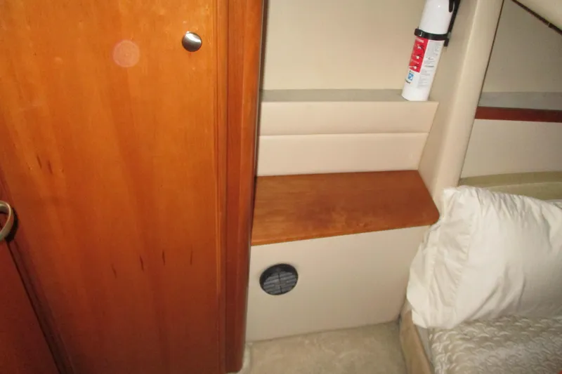 Slide: The Image of Interior of a 2004 Meridian 340 yacht cabin with wooden paneling and a fire extinguisher. - 30