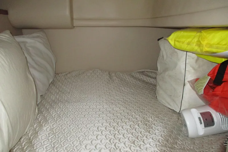 Slide: The Image of Cozy cabin bed in 2004 Meridian 340 yacht with pillows and storage items. - 31