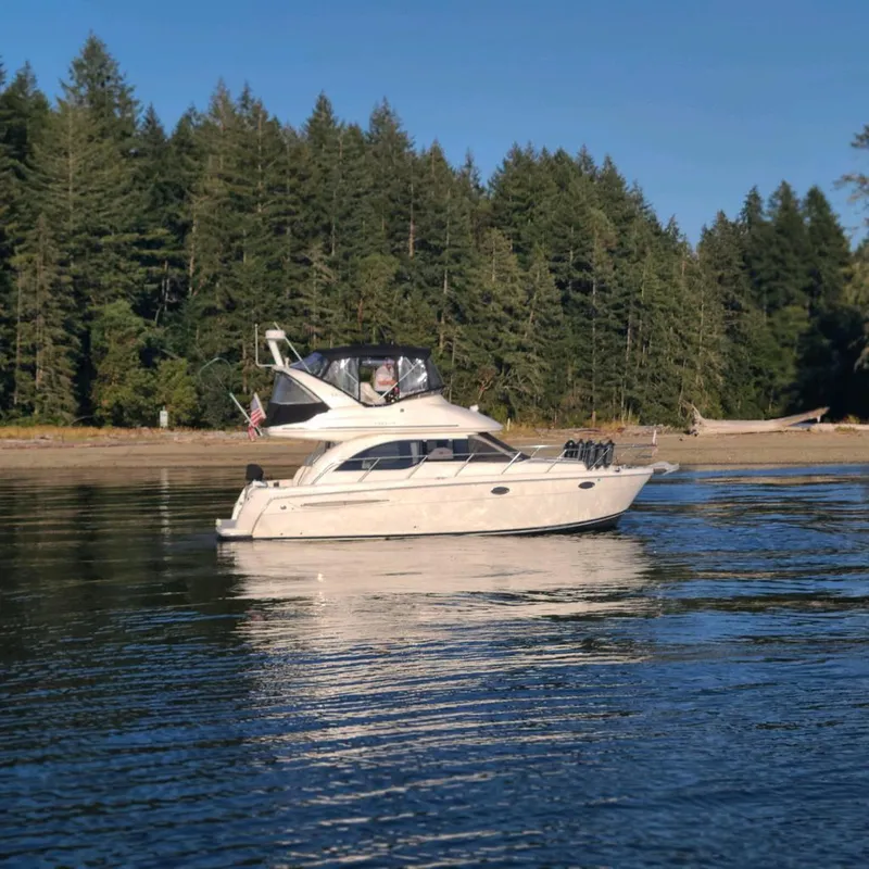 Slide: The Image of 2004 Meridian 341 yacht on calm water with forested shoreline in the background. - 4