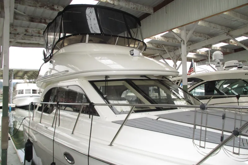 Slide: The Image of 2004 Meridian 340 yacht docked in a covered marina, showcasing sleek design and modern features. - 7