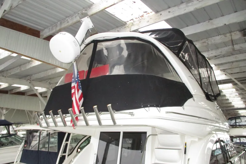 Slide: The Image of 2004 Meridian 340 yacht with radar and American flag in covered marina. - 9