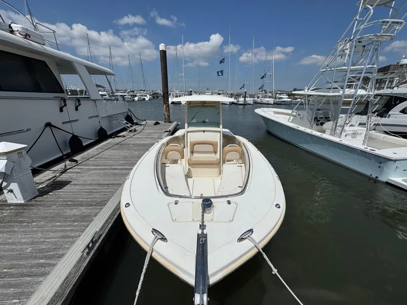 Slide: The Image of 2012 Scout 262 XSF boat docked at marina under clear blue sky. - 11