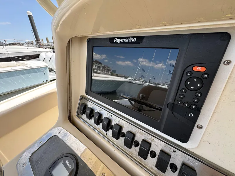 Slide: The Image of Control panel of a 2012 Scout 262 XSF boat with Raymarine display. - 13