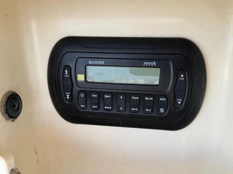 Slide: The Image of Marine radio control panel on 2012 Scout 262 XSF boat dashboard. - 14