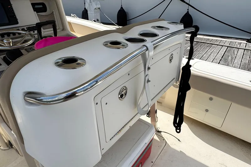 Slide: The Image of 2012 Scout 262 XSF boat interior with storage compartments and cup holders. - 15