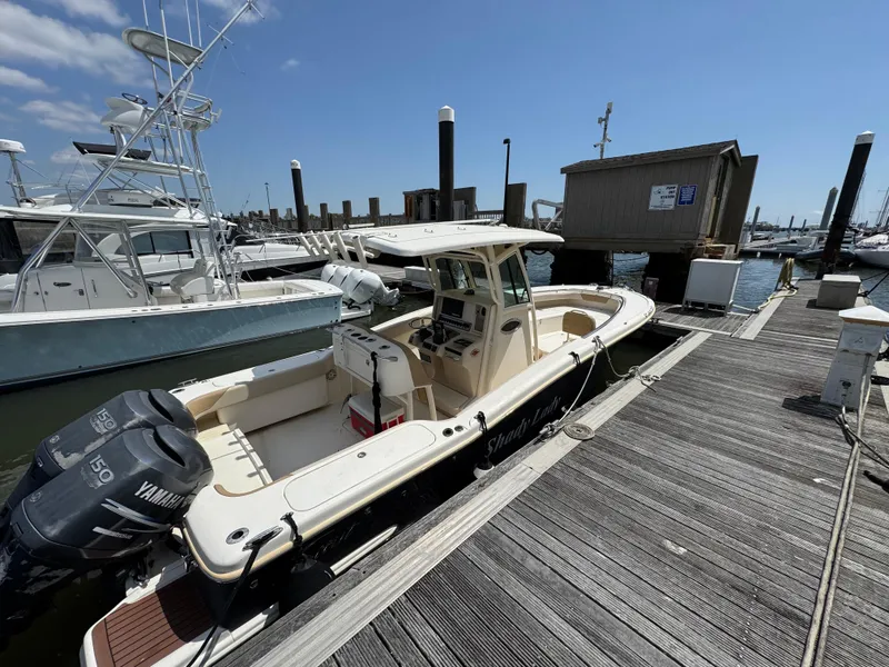 Slide: The Image of 2012 Scout 262 XSF boat docked at marina with Yamaha engines. - 4