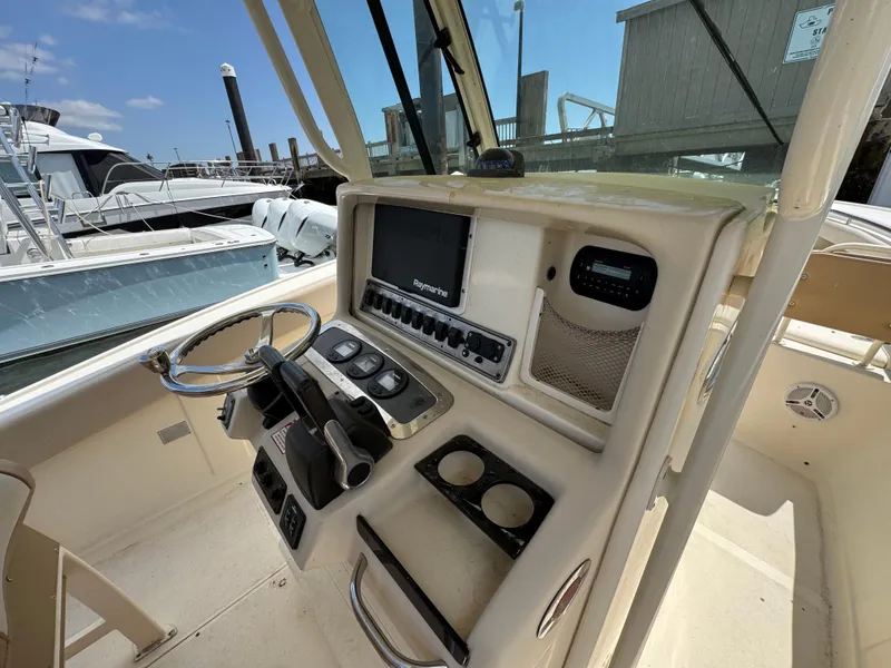 Slide: The Image of 2012 Scout 262 XSF boat dashboard with steering wheel and navigation controls. - 7