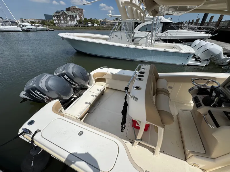 Slide: The Image of 2012 Scout 262 XSF boat with Yamaha engines docked at marina. - 8