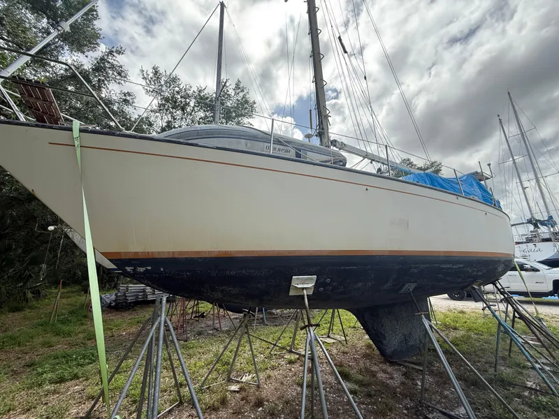 Slide: The Image of 1981 S2 11A sailboat on stands, cloudy sky background. - 10