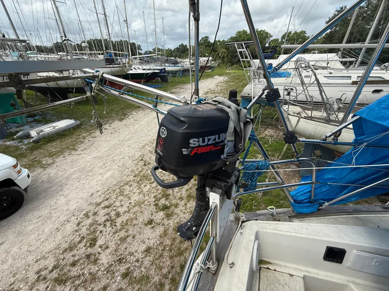 Slide: The Image of 1981 S2 11A sailboat with Suzuki outboard motor in a marina setting. - 14