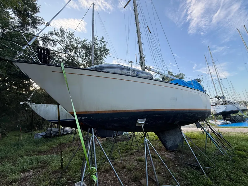 Slide: The Image of 1981 S2 11A sailboat on stands, ready for maintenance, with clear sky background. - 26