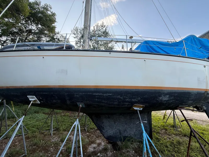 Slide: The Image of Sailboat S2 11A 1981 on stands, partially covered, outdoors. - 28