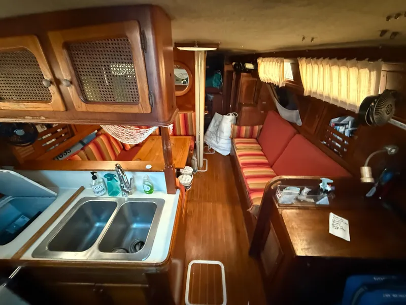 Slide: The Image of Interior of a 1981 S2 11A sailboat with wood finishes and striped seating. - 35