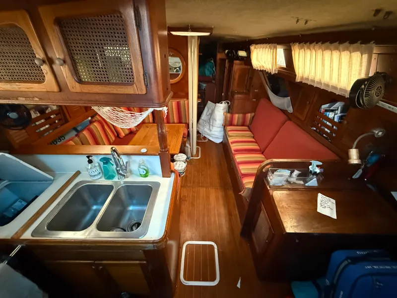 Slide: The Image of Interior of 1981 S2 11A sailboat with wood finish, kitchenette, and seating area. - 37