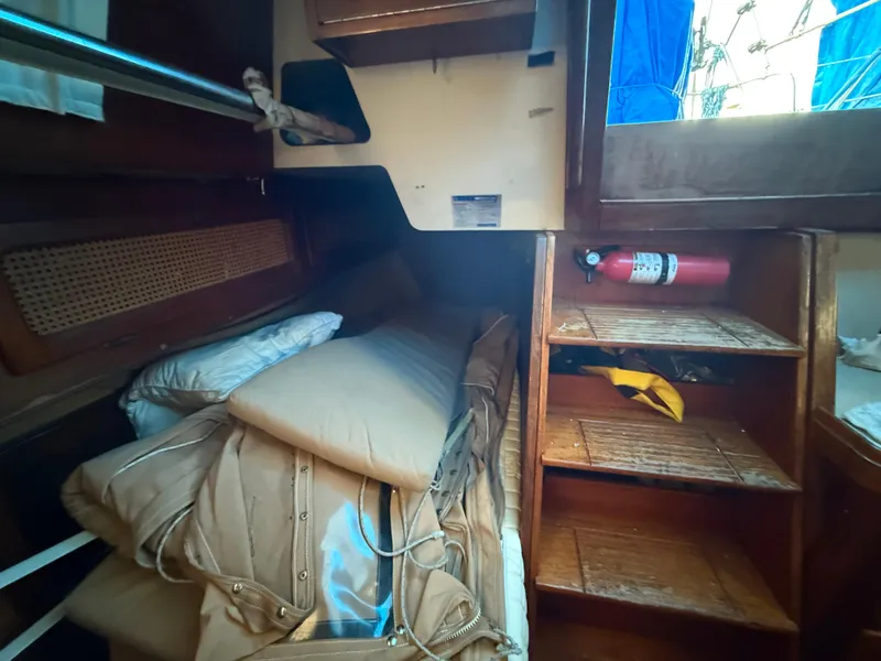 Slide: The Image of Interior of 1981 S2 11A sailboat with cushions and fire extinguisher. - 40