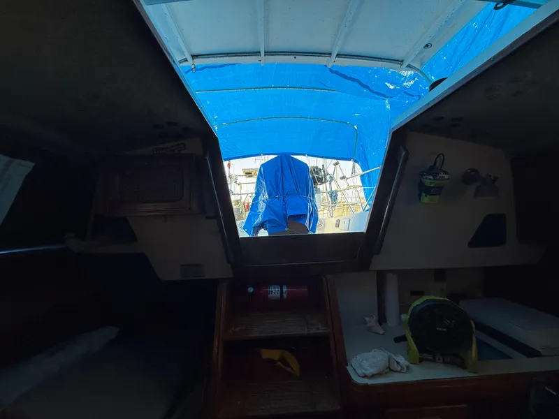 Slide: The Image of Interior view of a 1981 S2 11A sailboat cabin with blue canopy. - 42