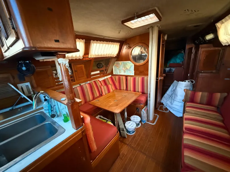 Slide: The Image of Interior of 1981 S2 11A sailboat with wood finish and striped seating. - 44