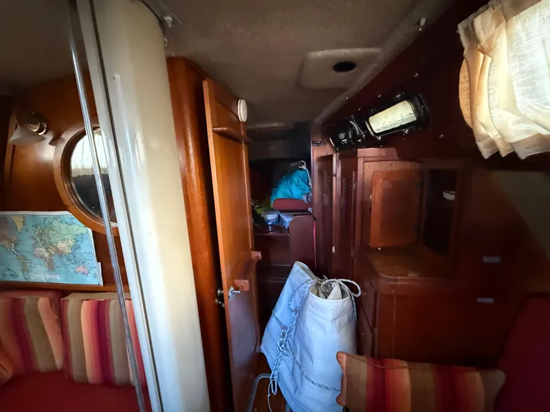 Slide: The Image of Interior of a 1981 S2 11A sailboat with wooden cabinetry and striped seating. - 45