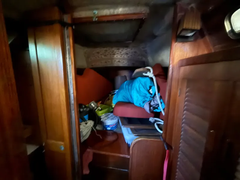 Slide: The Image of Interior of a 1981 S2 11A sailboat cabin with storage and seating area. - 46