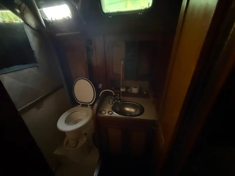 Slide: The Image of Compact bathroom in a 1981 S2 11A sailboat with toilet and sink. - 47