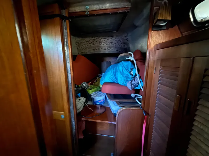 Slide: The Image of Interior of a 1981 S2 11A sailboat with cluttered cabin space. - 49
