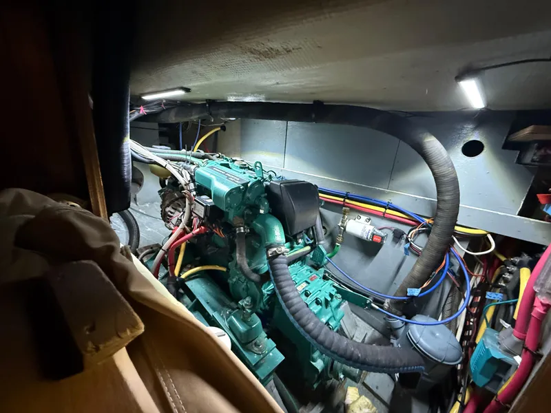 Slide: The Image of Engine compartment of 1981 S2 11A sailboat with visible wiring and components. - 58